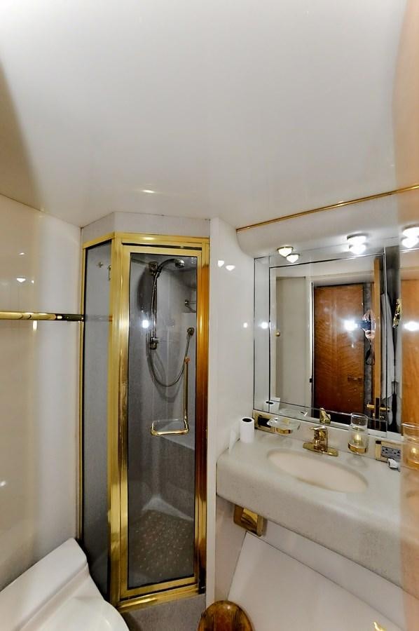 a bathroom with a glass shower door aboard CAMY Yacht for Sale