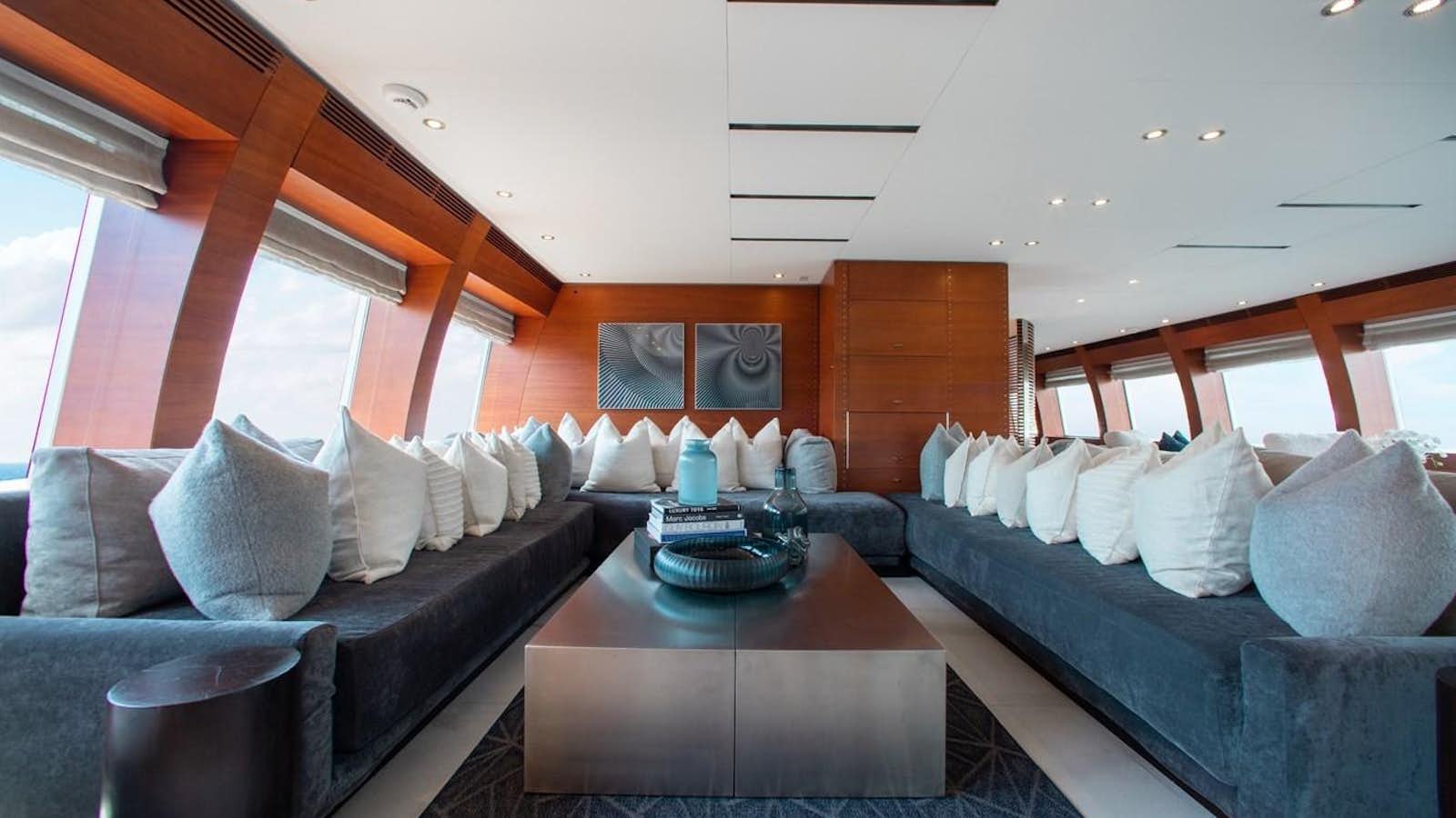 a living room with a couch and a coffee table aboard BLUE ICE Yacht for Sale