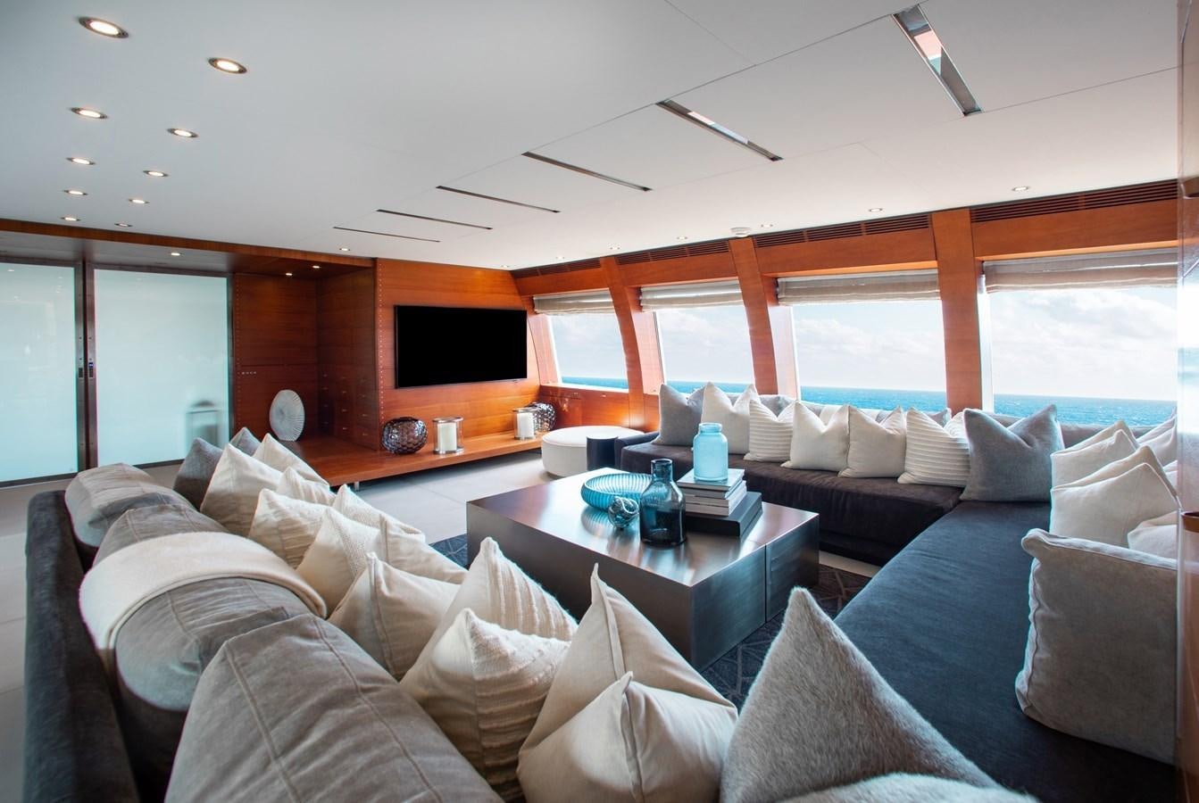 a living room with a couch and a coffee table aboard BLUE ICE Yacht for Sale