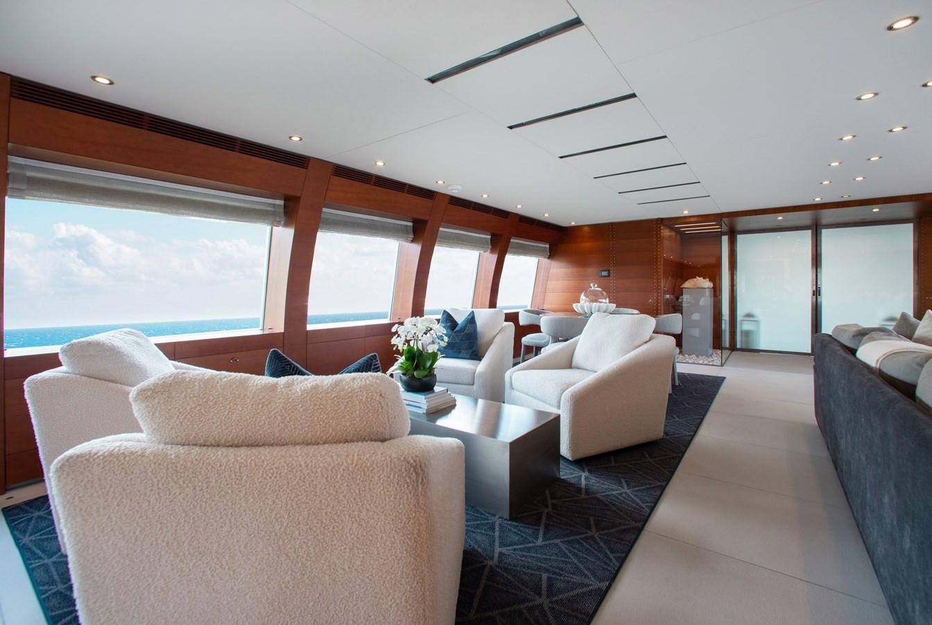 a living room with couches and a table aboard BLUE ICE Yacht for Sale