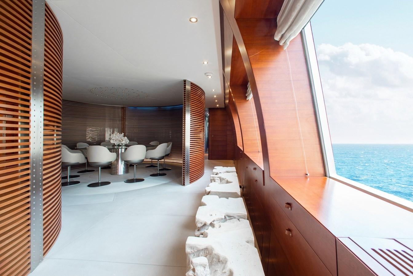 a room with a table chairs and a large window aboard BLUE ICE Yacht for Sale