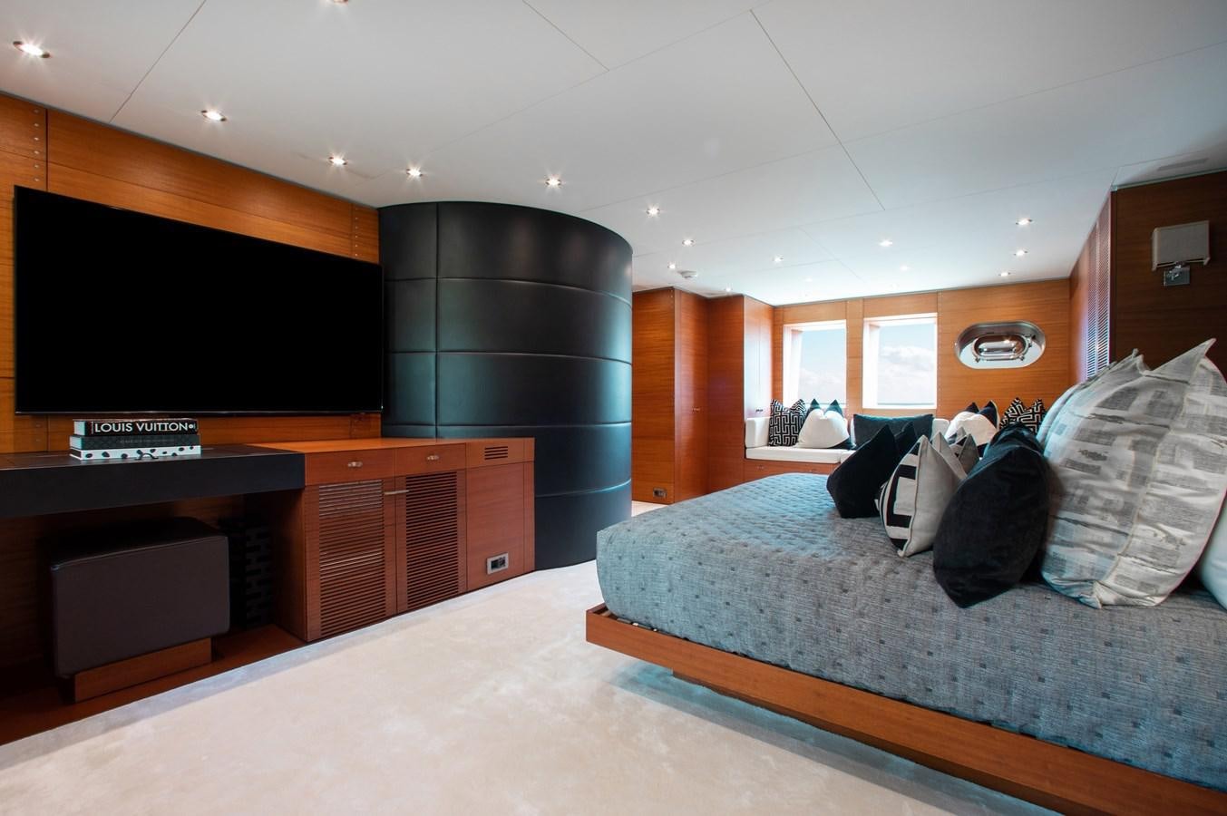 a bedroom with a bed and desk aboard BLUE ICE Yacht for Sale