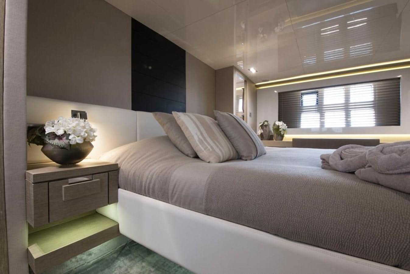 a bedroom with a bed and a desk aboard SUMMER BREEZE Yacht for Sale
