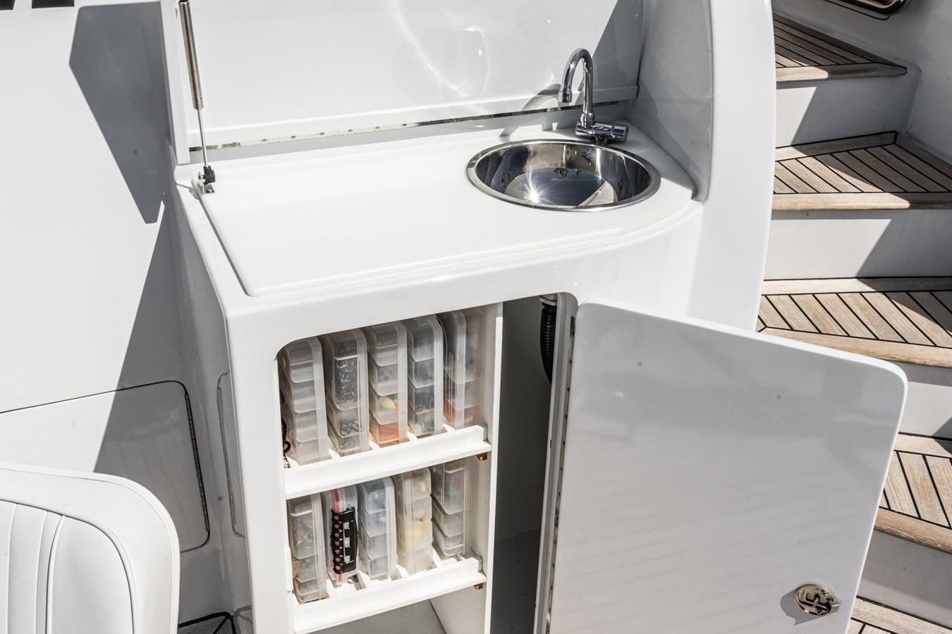 a white kitchen with shelves aboard PHANTOM Yacht for Sale