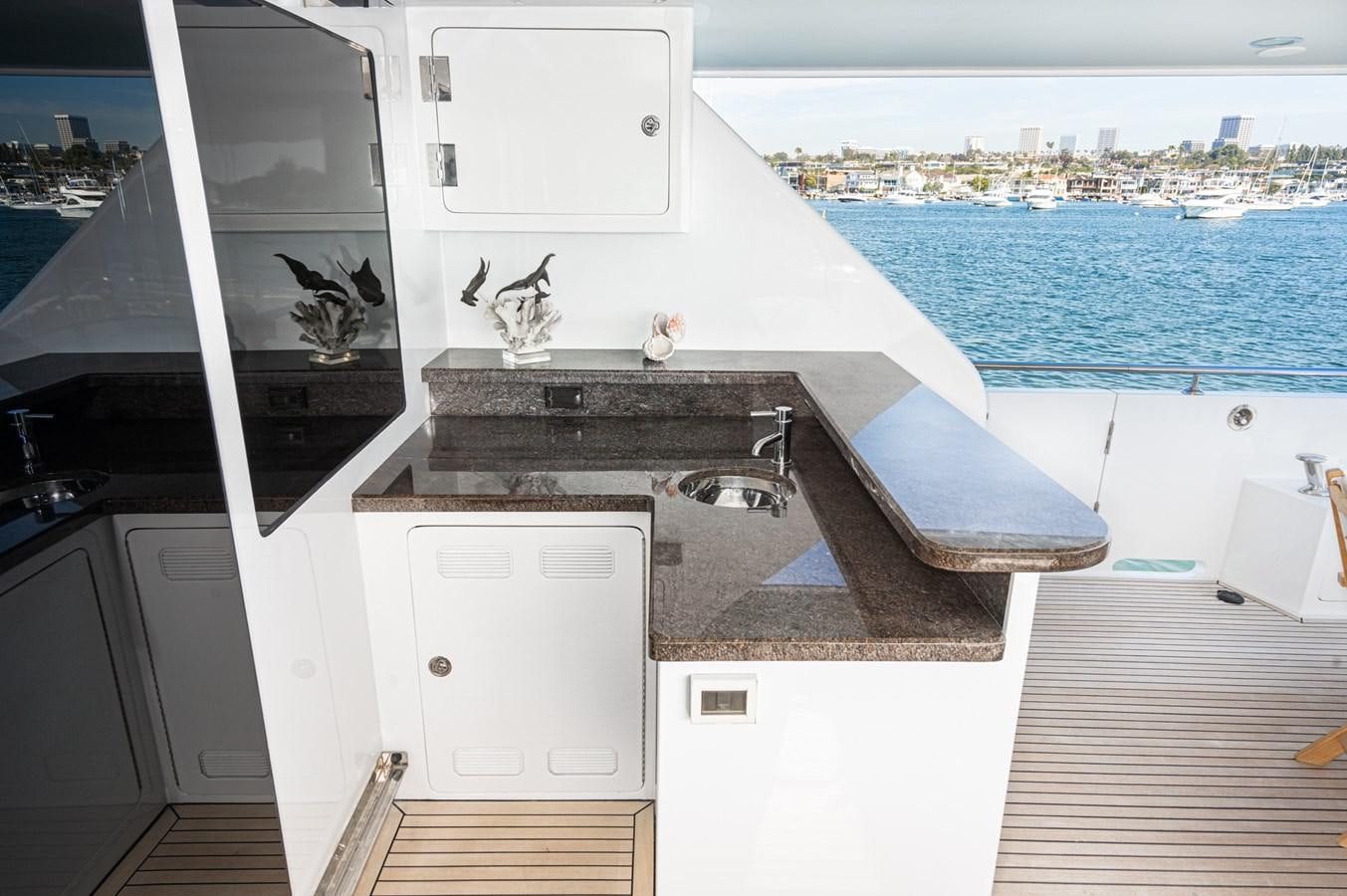 a kitchen with a sink and a large window aboard PHANTOM Yacht for Sale