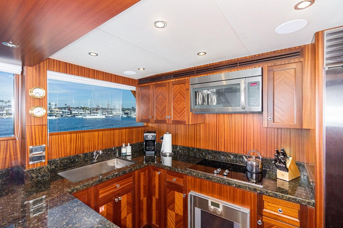 a kitchen with wooden cabinets aboard PHANTOM Yacht for Sale