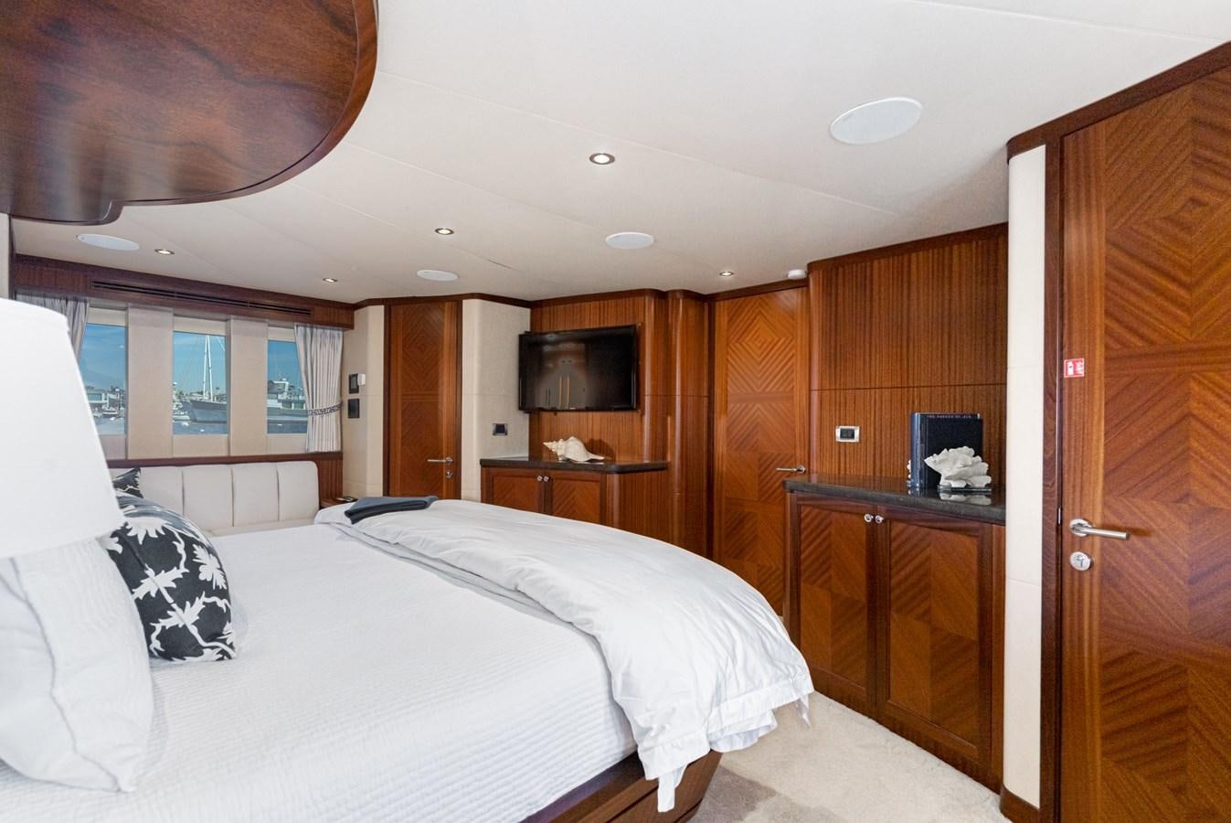 a bedroom with a wood cabinet aboard PHANTOM Yacht for Sale