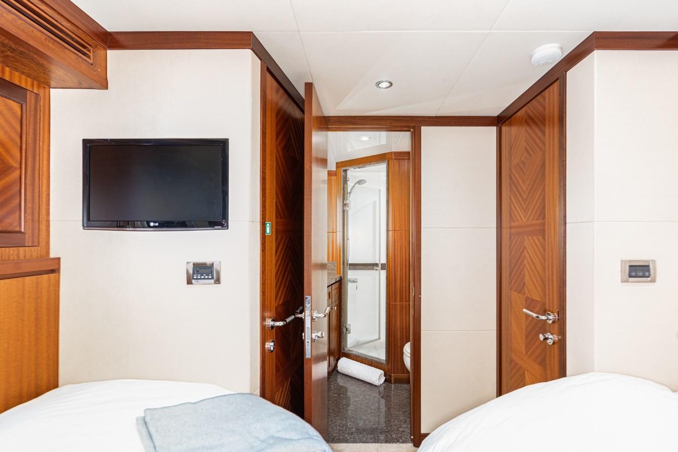 a room with a tv and a bed aboard PHANTOM Yacht for Sale