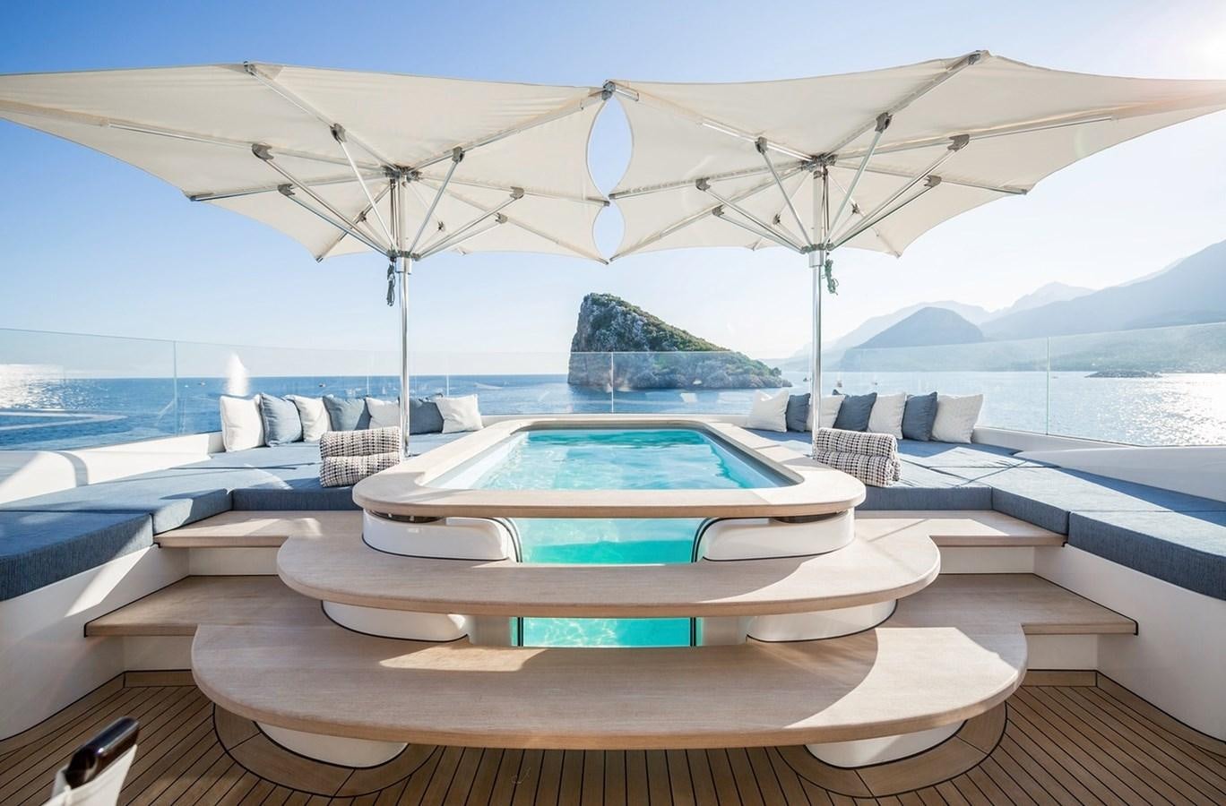 a pool with a large white tent aboard RUYA Yacht for Sale