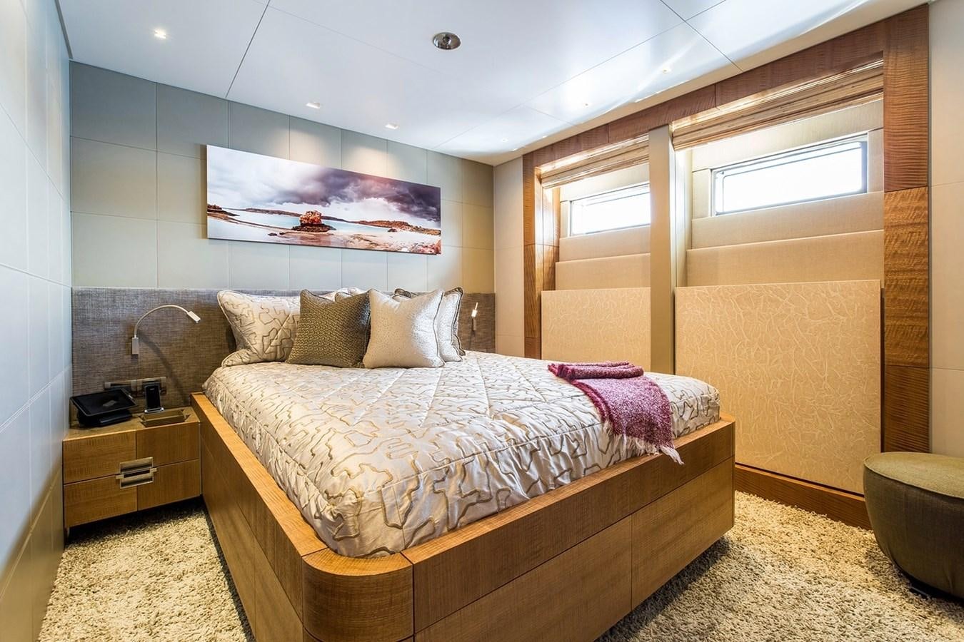 a bedroom with a bed and a window aboard RUYA Yacht for Sale