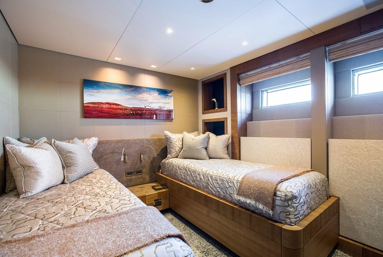 a bedroom with two beds aboard RUYA Yacht for Sale