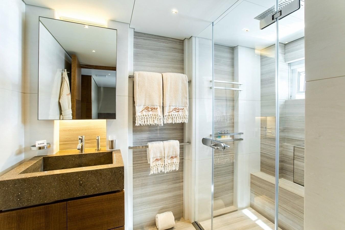 a bathroom with a glass shower aboard RUYA Yacht for Sale
