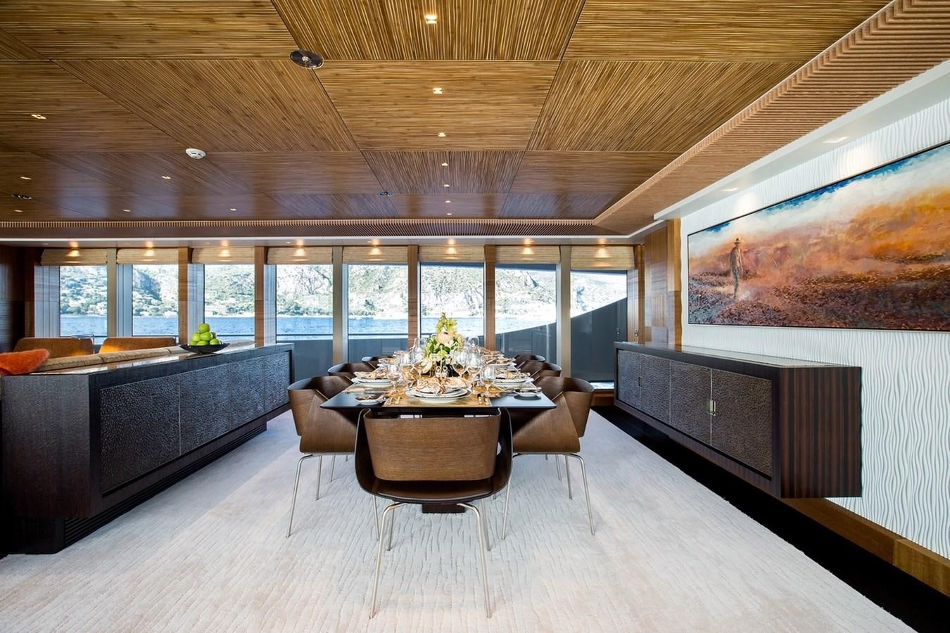 a large living room with a large table and couches aboard RUYA Yacht for Sale