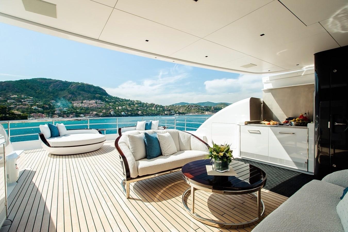 a room with a couch and a table and a view of the ocean aboard RUYA Yacht for Sale