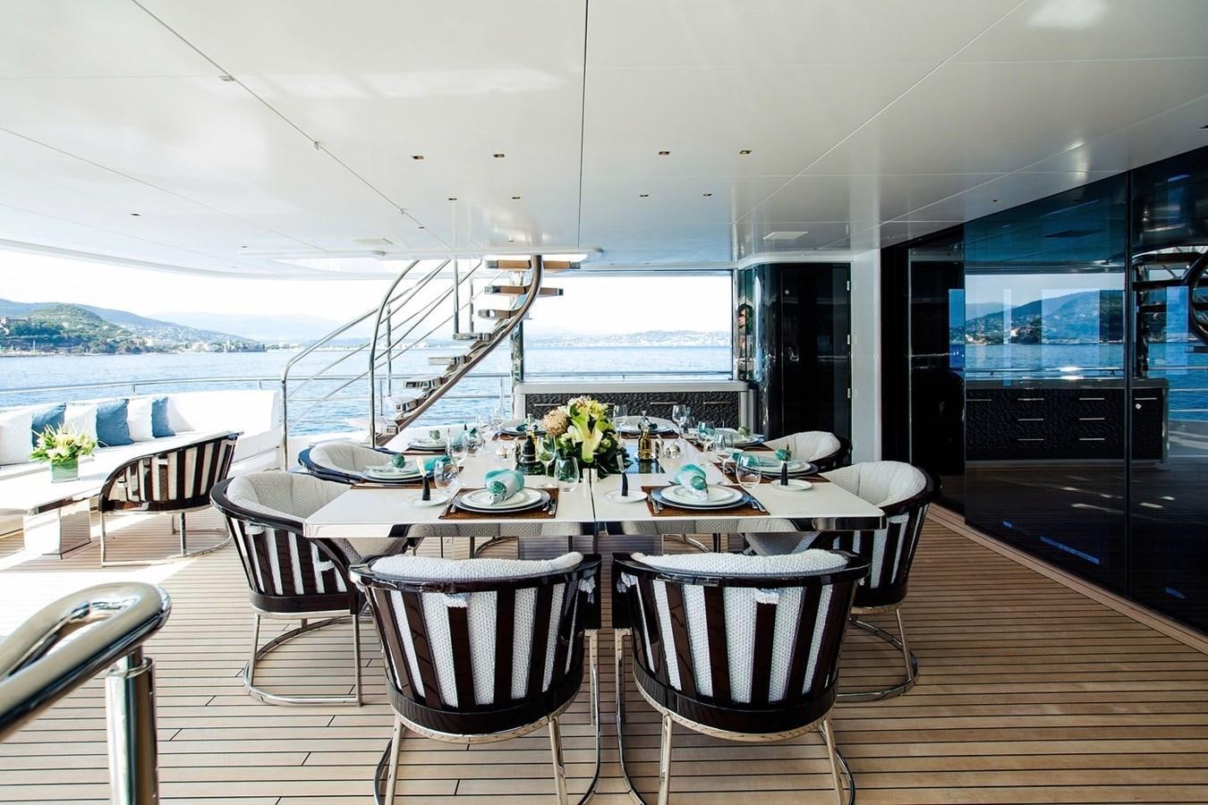 a room with a table and chairs aboard RUYA Yacht for Sale