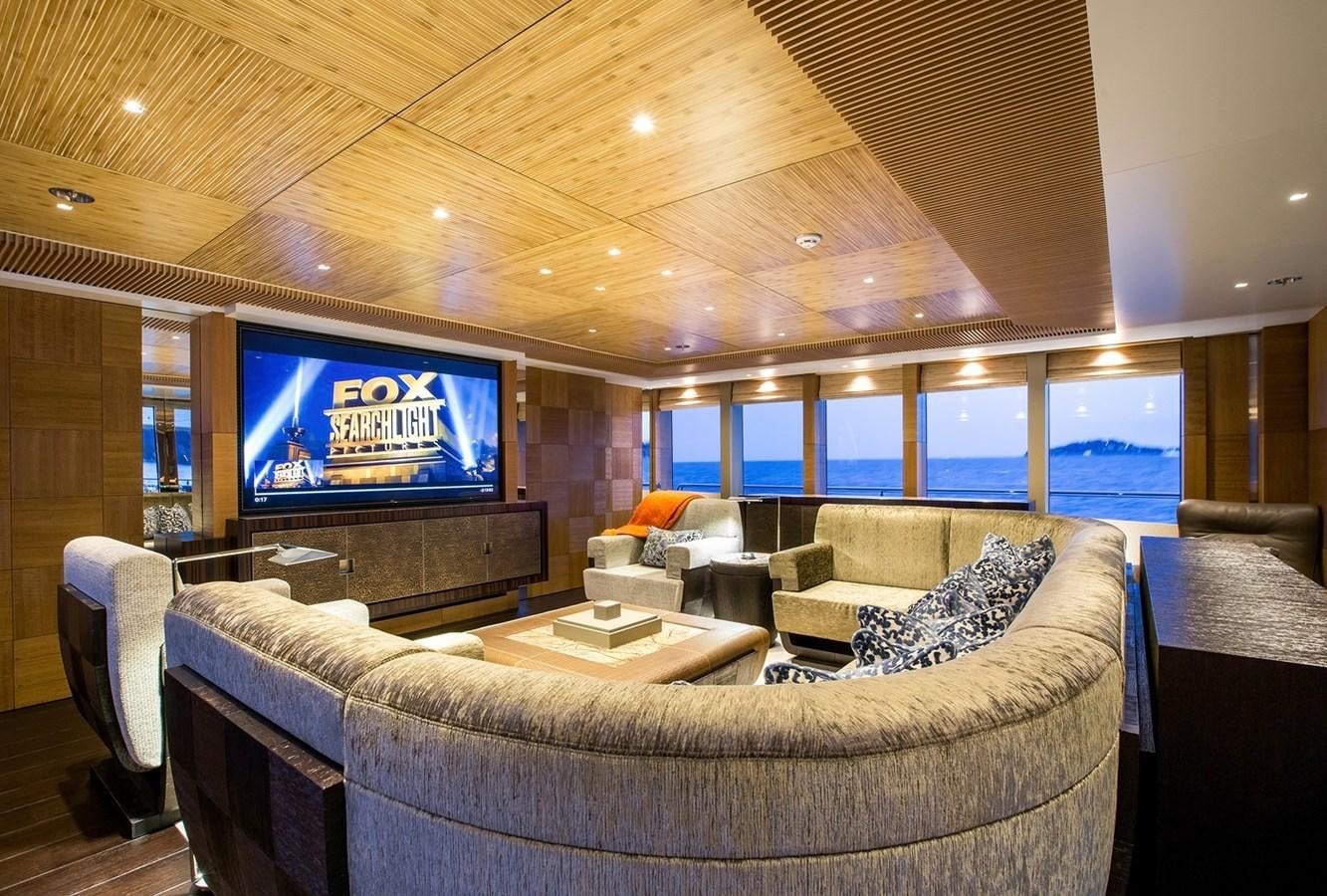 a living room with a large screen aboard RUYA Yacht for Sale