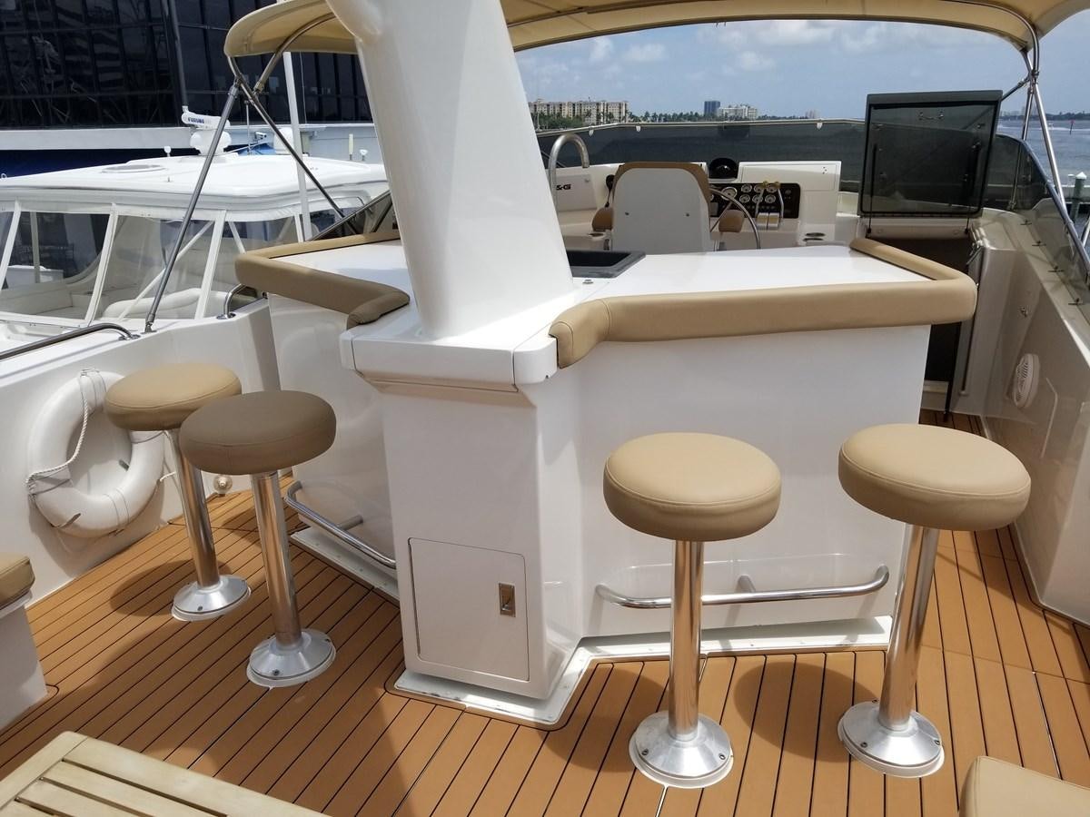 a white table with stools aboard SEA SENOR Yacht for Sale