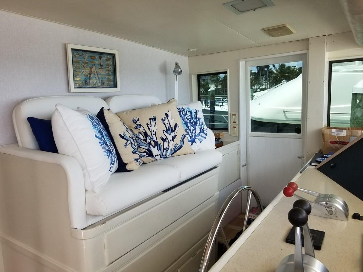 a white couch with blue and white pillows aboard SEA SENOR Yacht for Sale