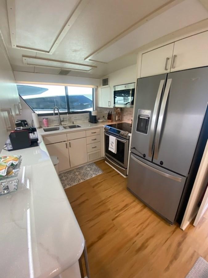 a kitchen with a fridge and a sink aboard SEA SENOR Yacht for Sale