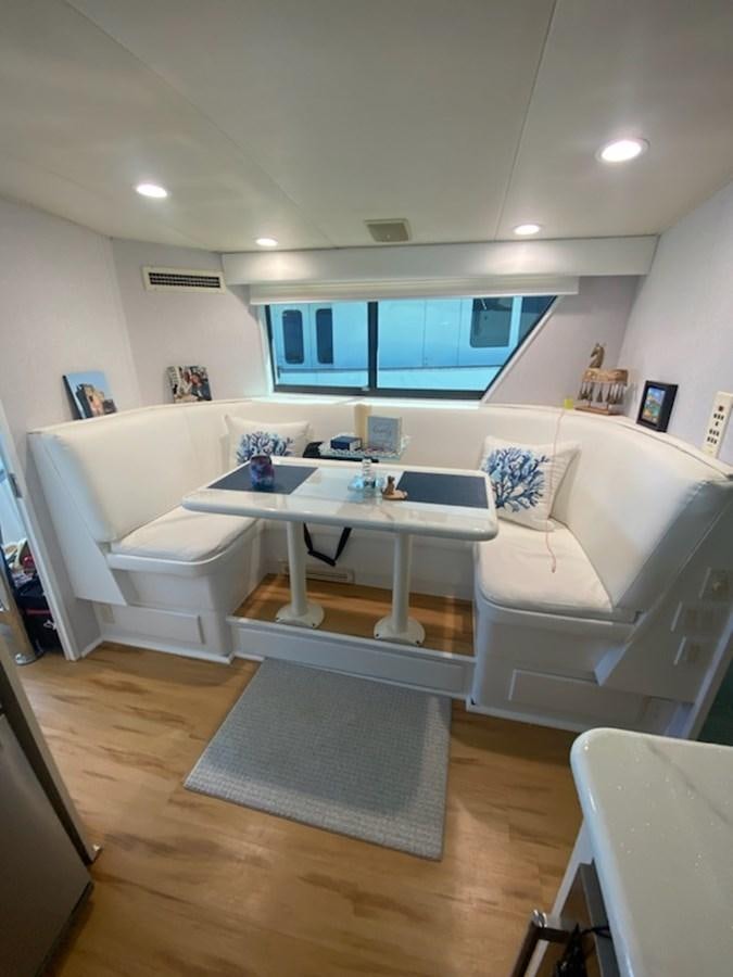 a living room with a table and couches aboard SEA SENOR Yacht for Sale