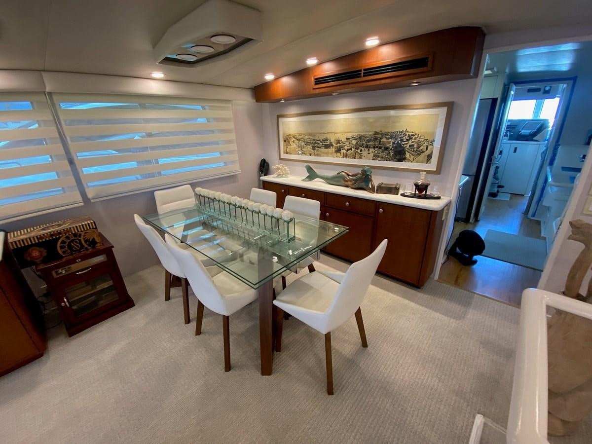 a room with a table and chairs aboard SEA SENOR Yacht for Sale