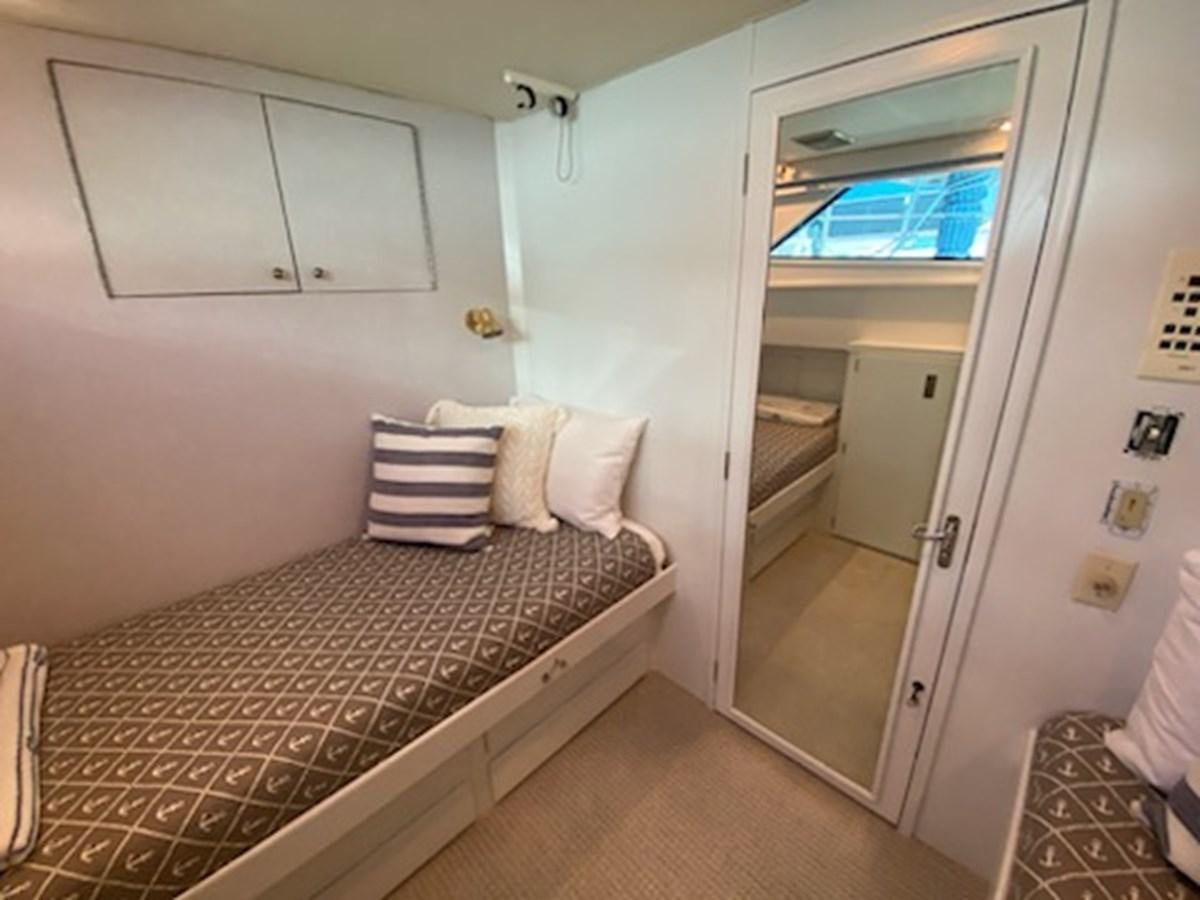a bedroom with a bed and a door aboard SEA SENOR Yacht for Sale