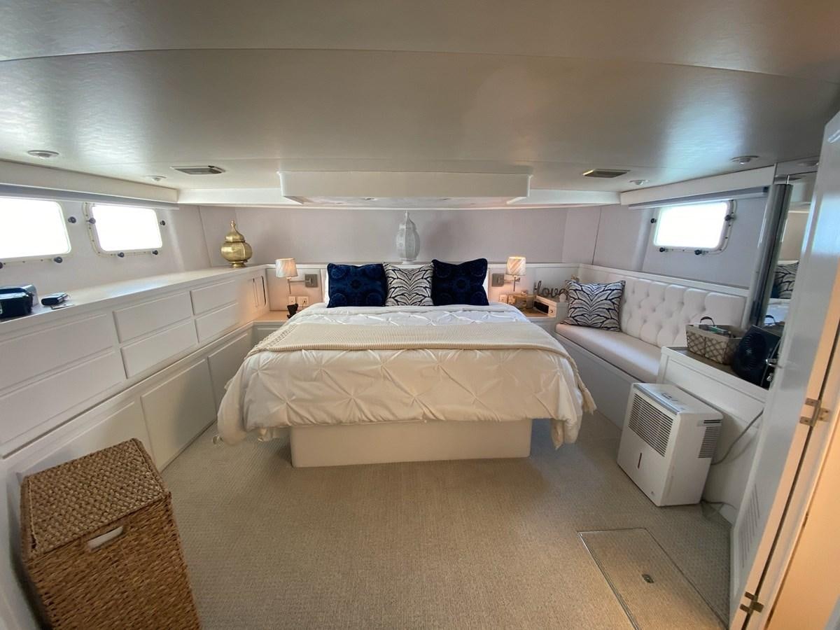 a room with a bed and a couch aboard SEA SENOR Yacht for Sale