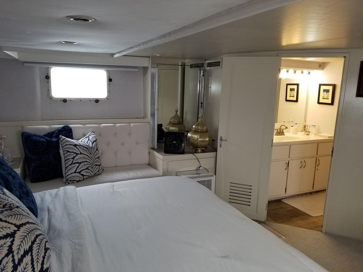 a bedroom with a bed and a desk aboard SEA SENOR Yacht for Sale