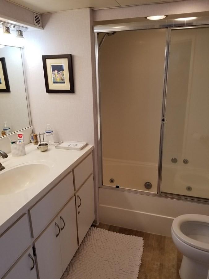 a bathroom with a shower unit and a toilet aboard SEA SENOR Yacht for Sale