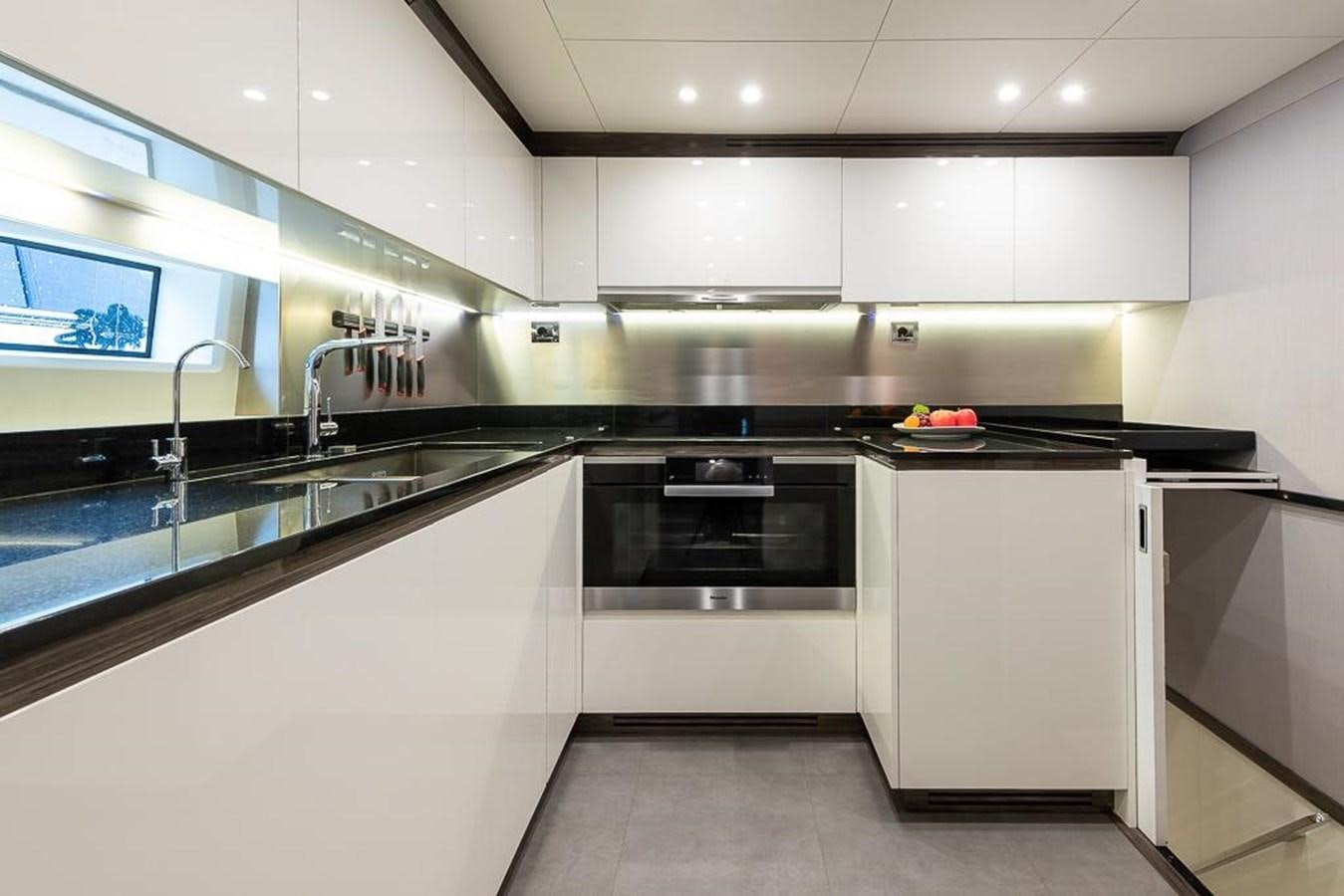 a kitchen with white cabinets aboard DESIREE Yacht for Sale
