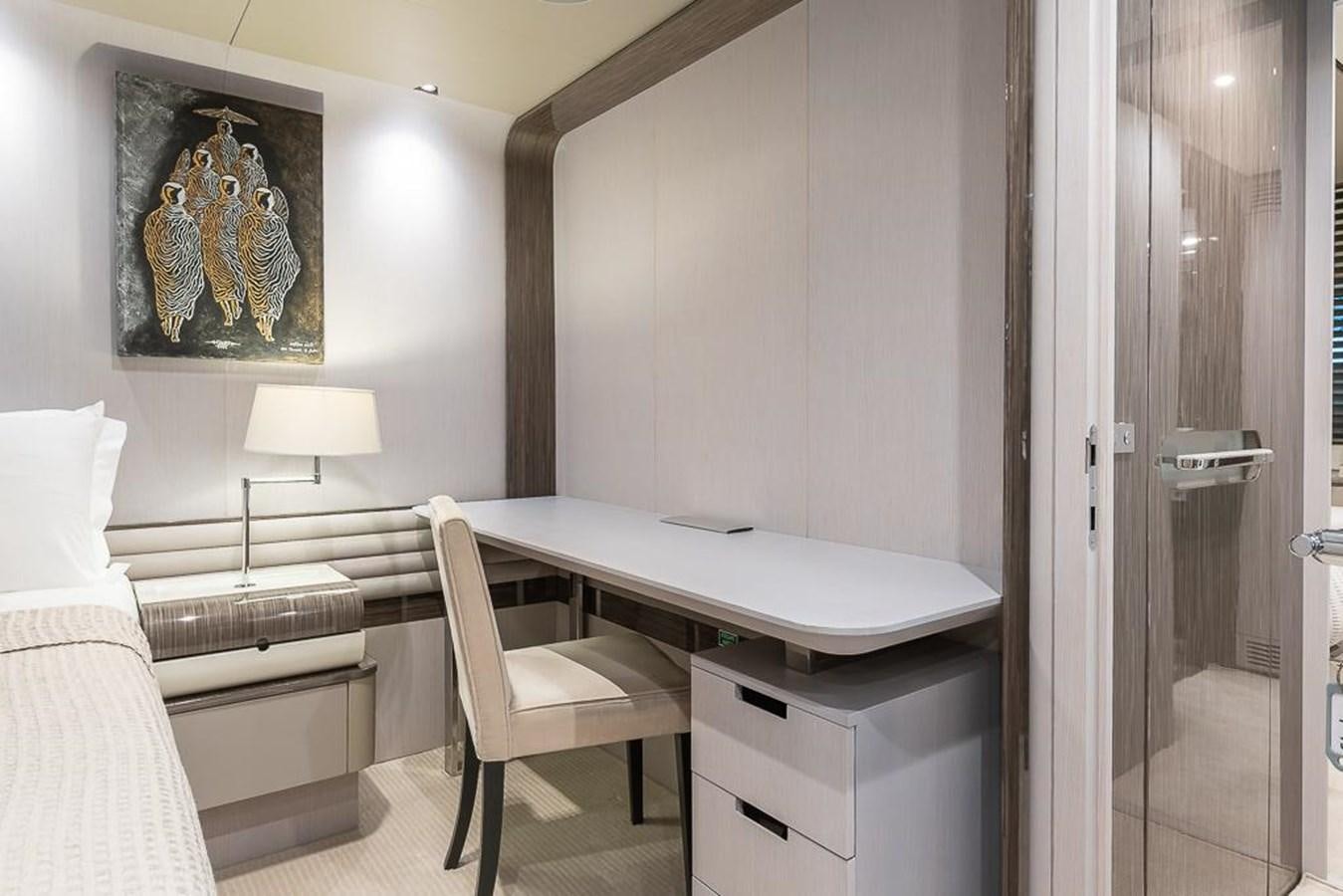 a room with a desk and a bed aboard DESIREE Yacht for Sale