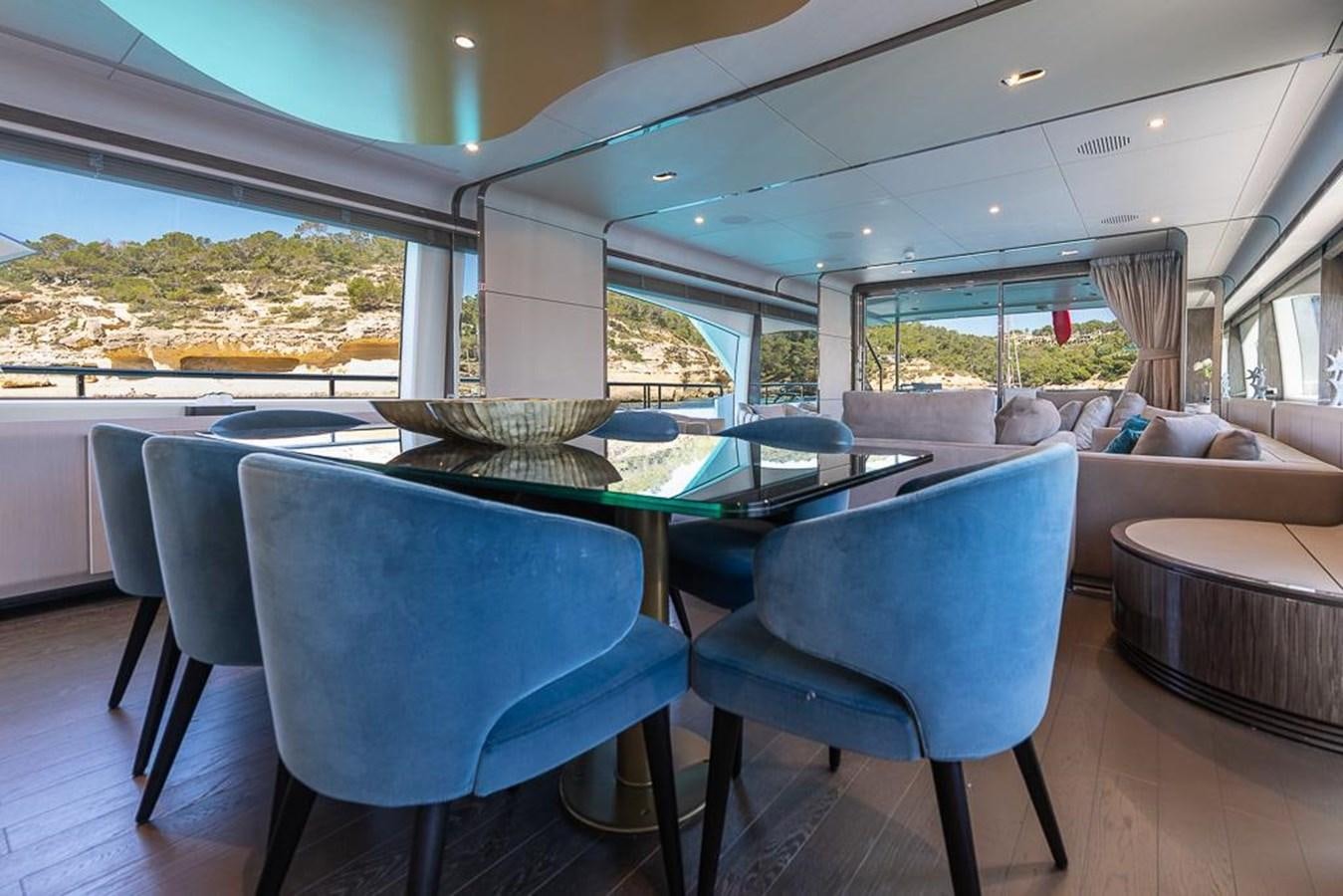 a large room with a table and chairs aboard DESIREE Yacht for Sale