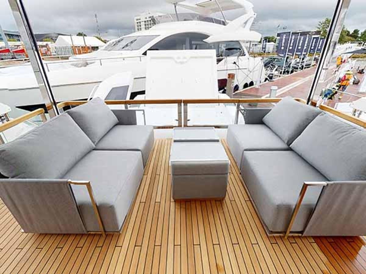 a room with a couch and a table with chairs on it aboard 88 YACHT - M/Y IP Yacht for Sale