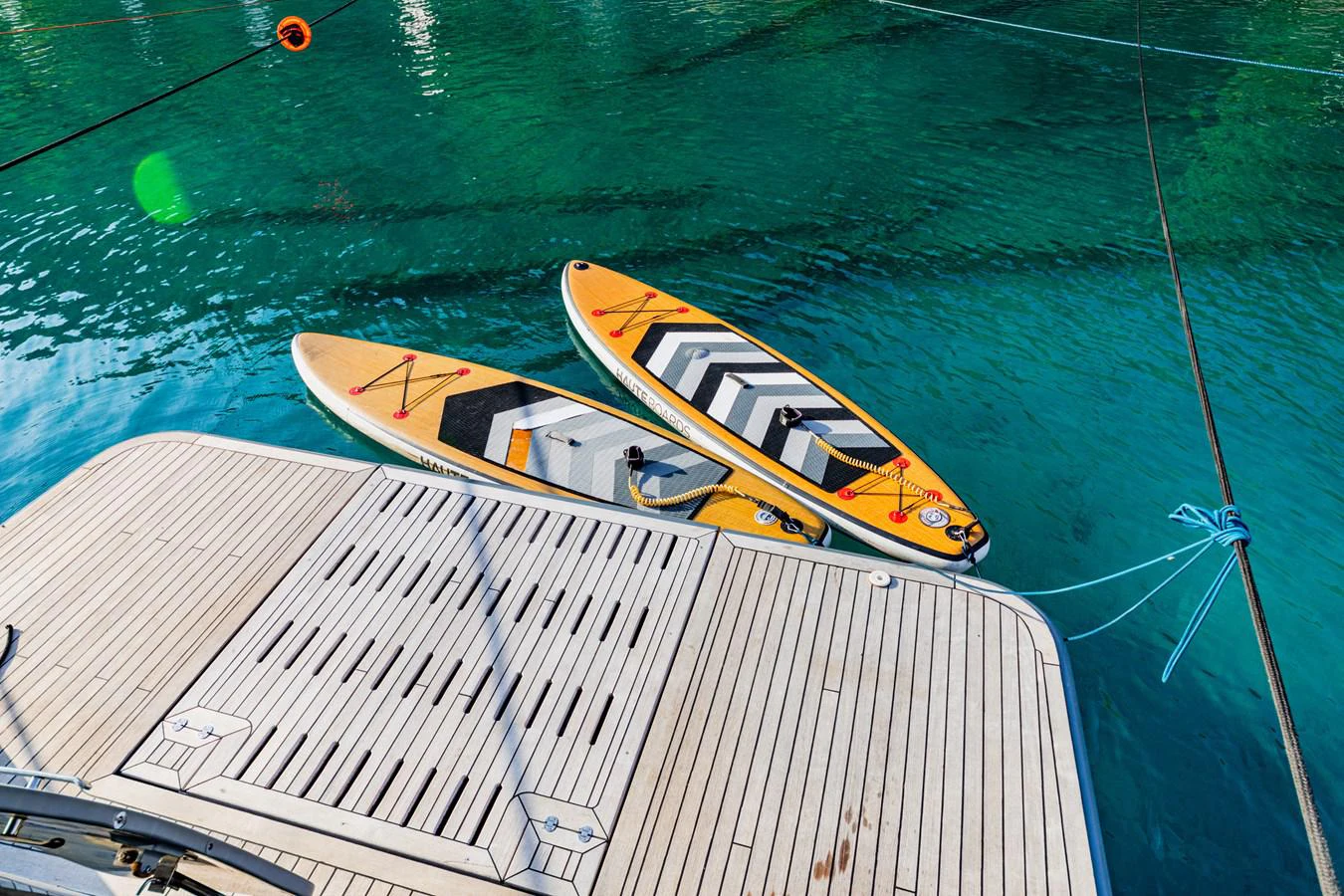 a yellow boat on a deck aboard WATER Yacht for Sale