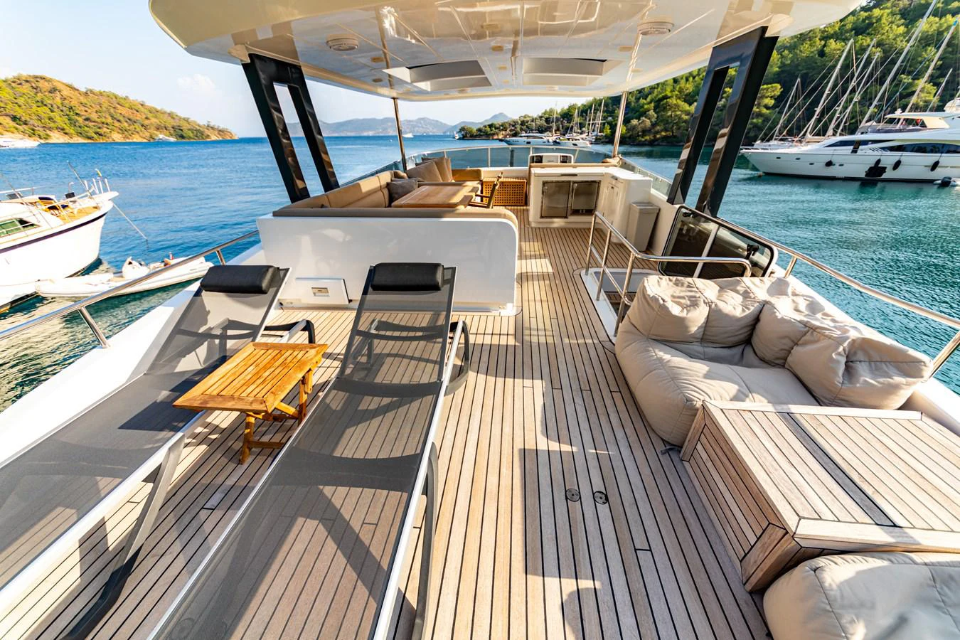a deck with a chair and a boat on it aboard WATER Yacht for Sale