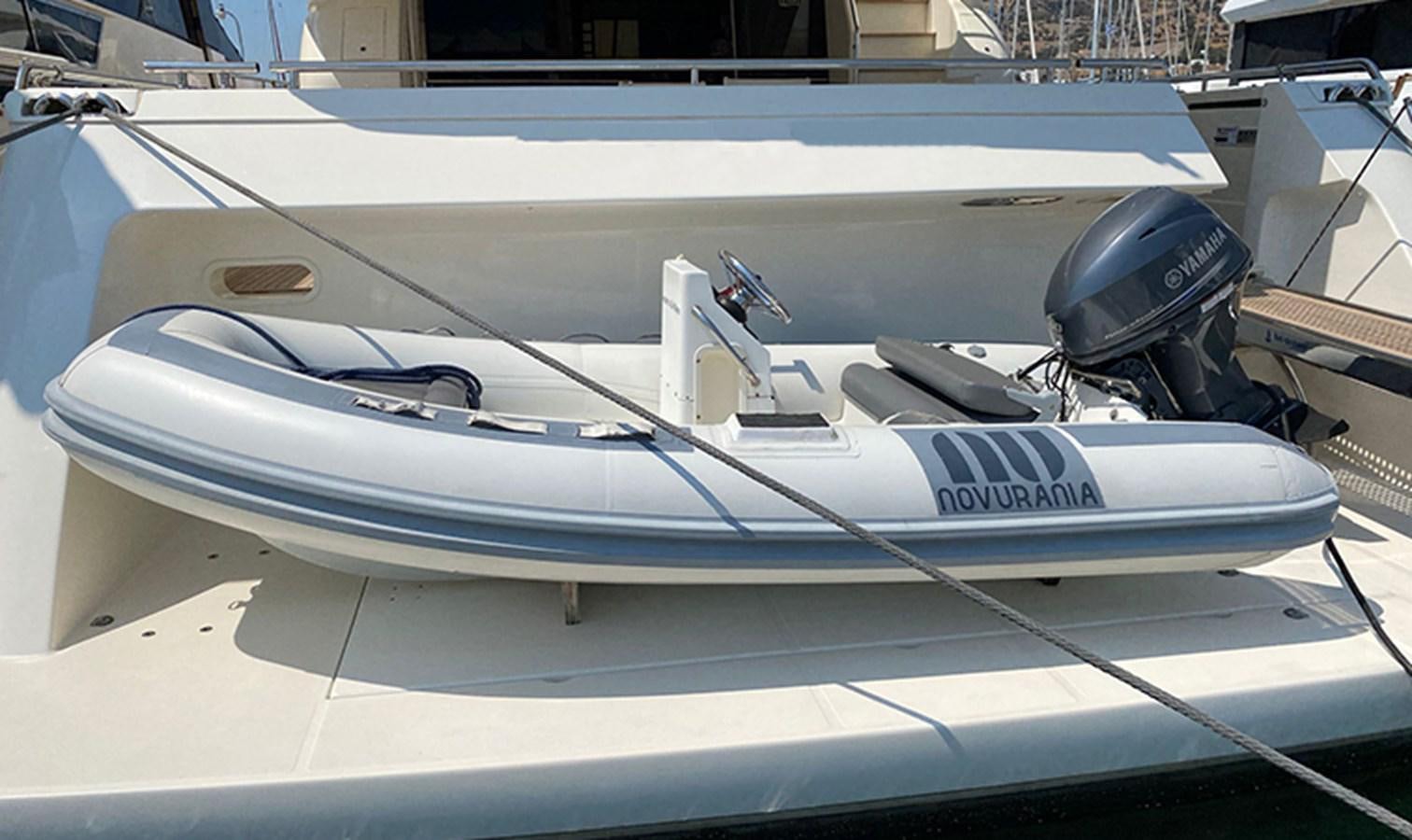 a white boat with a black and silver boat in the water aboard DELMARE Yacht for Sale