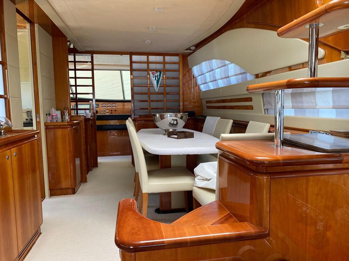 a room with a table chairs and a window aboard DELMARE Yacht for Sale