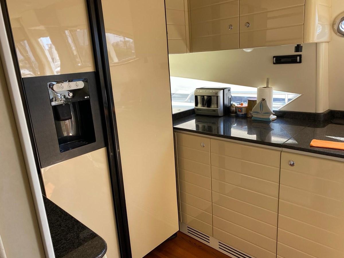 a kitchen with a stainless steel refrigerator aboard DELMARE Yacht for Sale