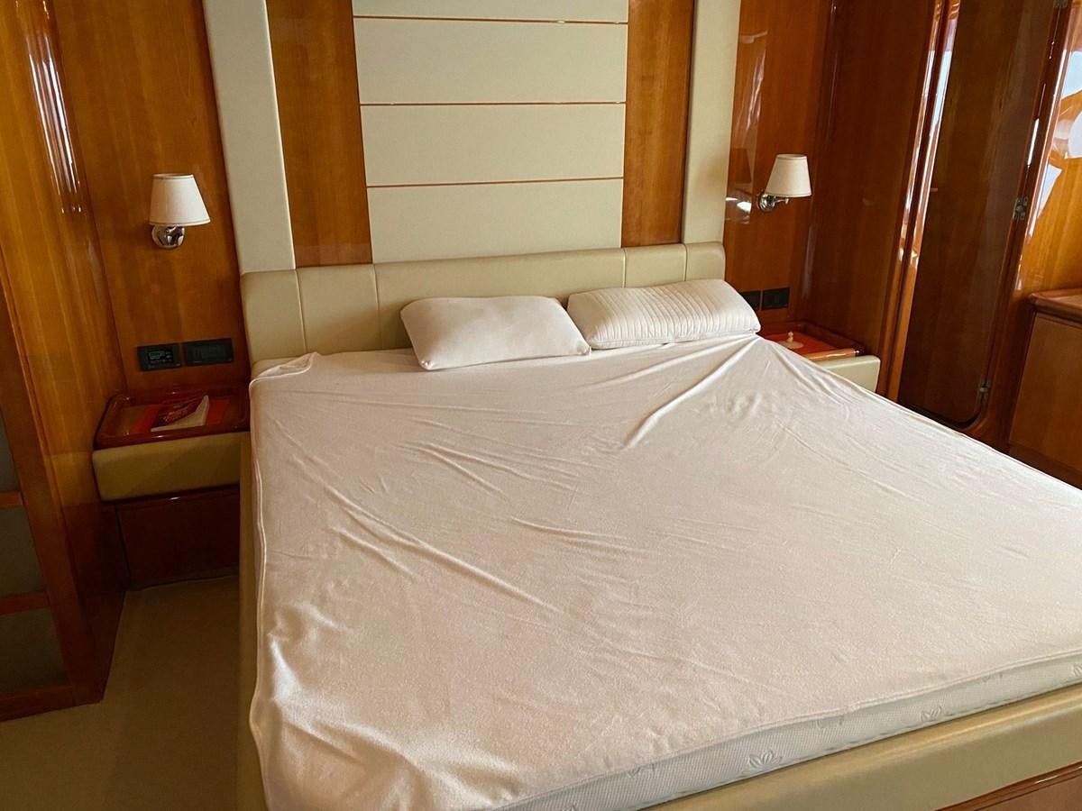 a bed with white sheets aboard DELMARE Yacht for Sale