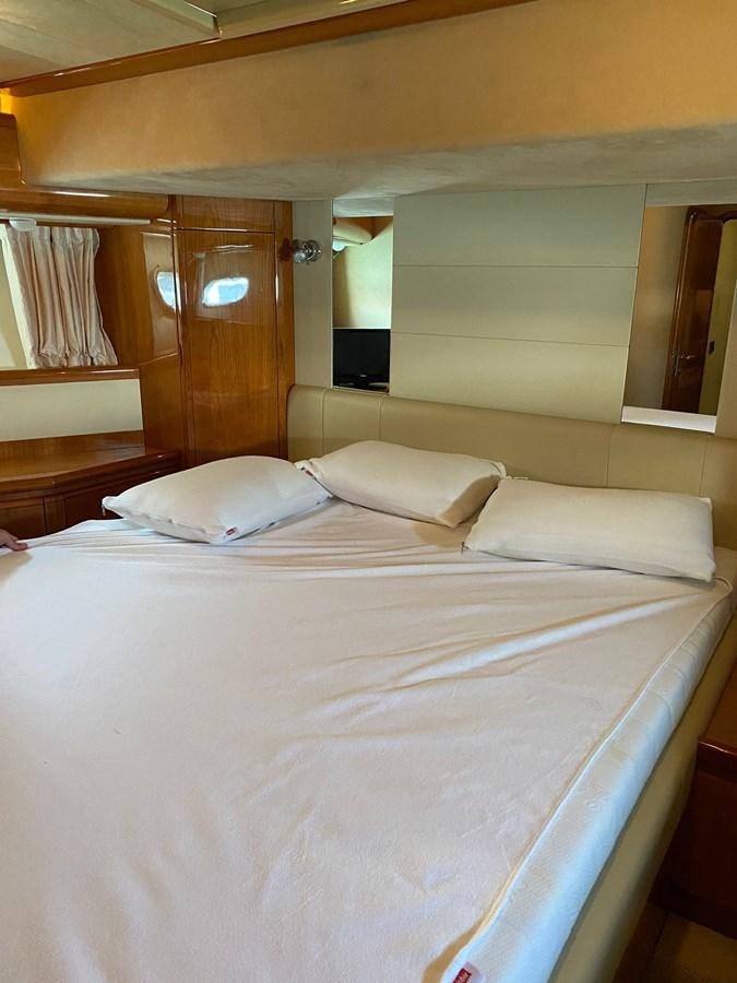 a bed with white sheets aboard DELMARE Yacht for Sale