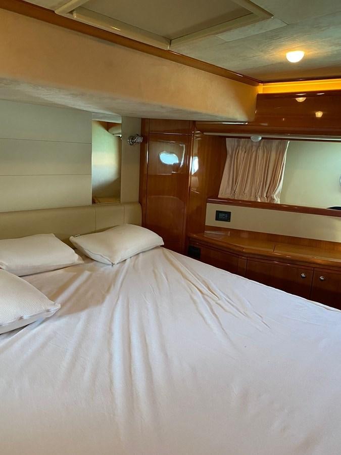 a bed with white sheets aboard DELMARE Yacht for Sale