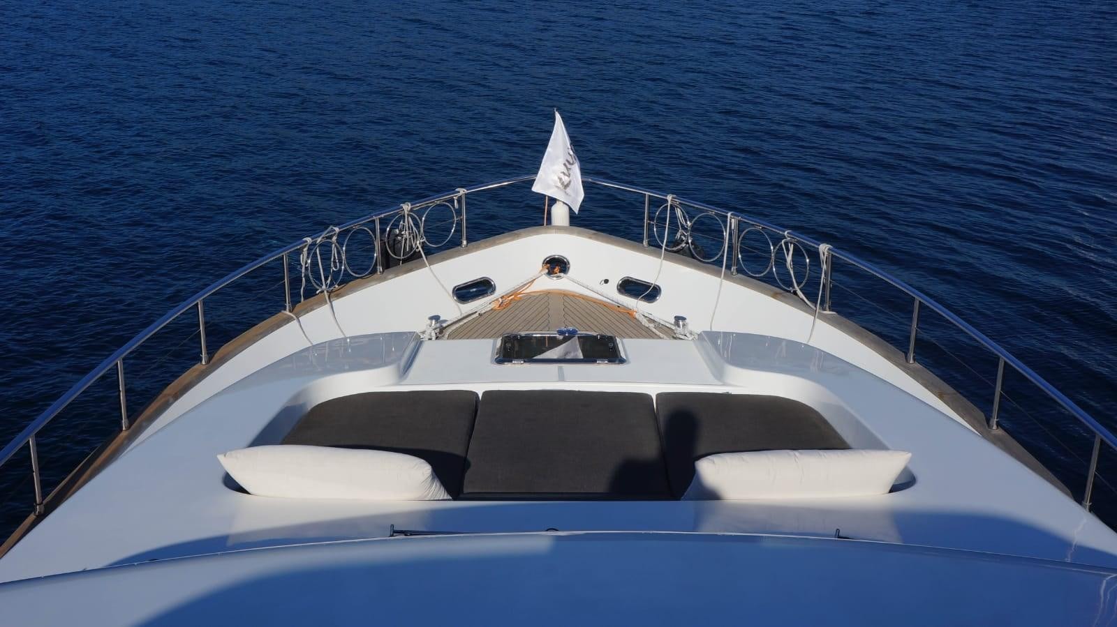 a white boat on the water aboard KUUM Yacht for Sale
