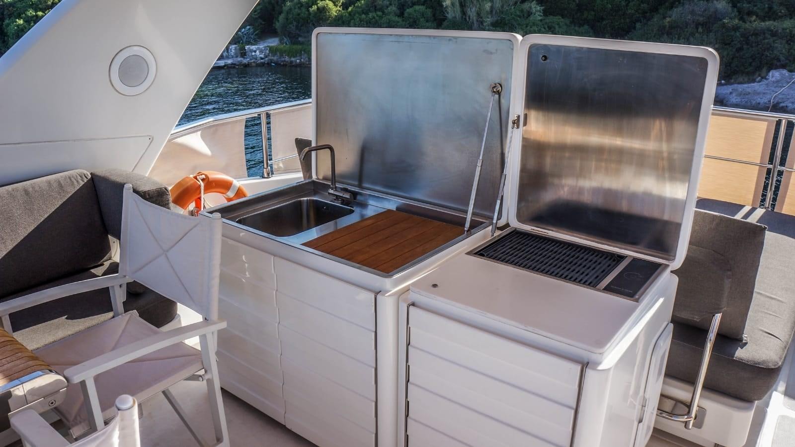 a large white boat with a grill aboard KUUM Yacht for Sale