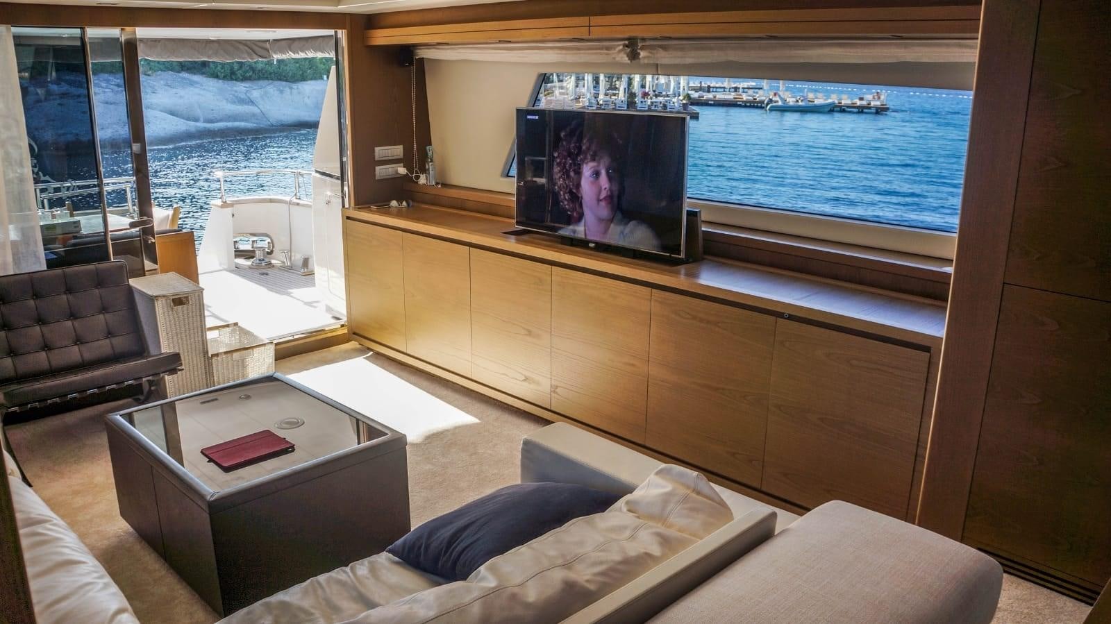 a room with a tv and a couch aboard KUUM Yacht for Sale