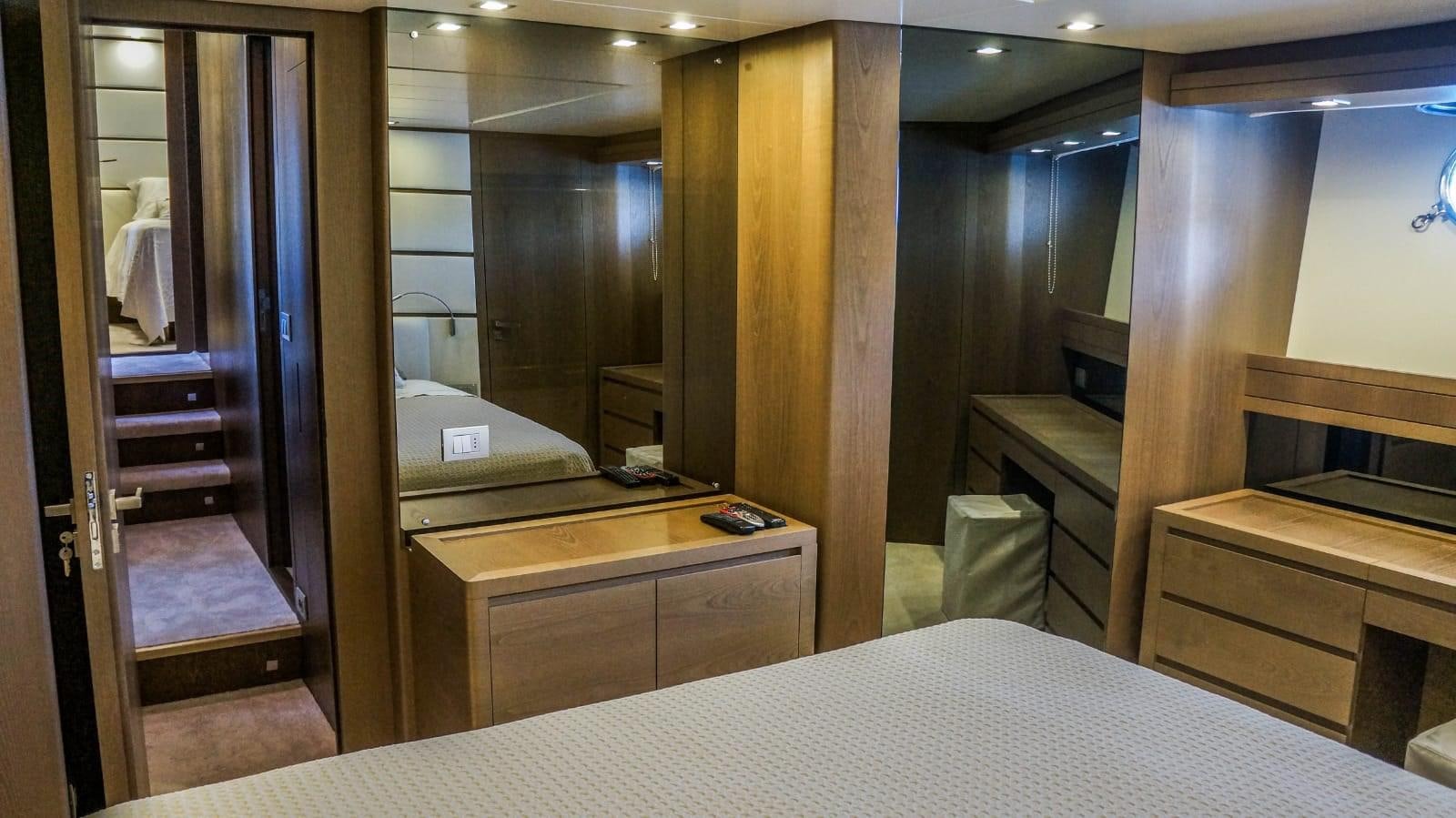 a room with a bed and a desk aboard KUUM Yacht for Sale