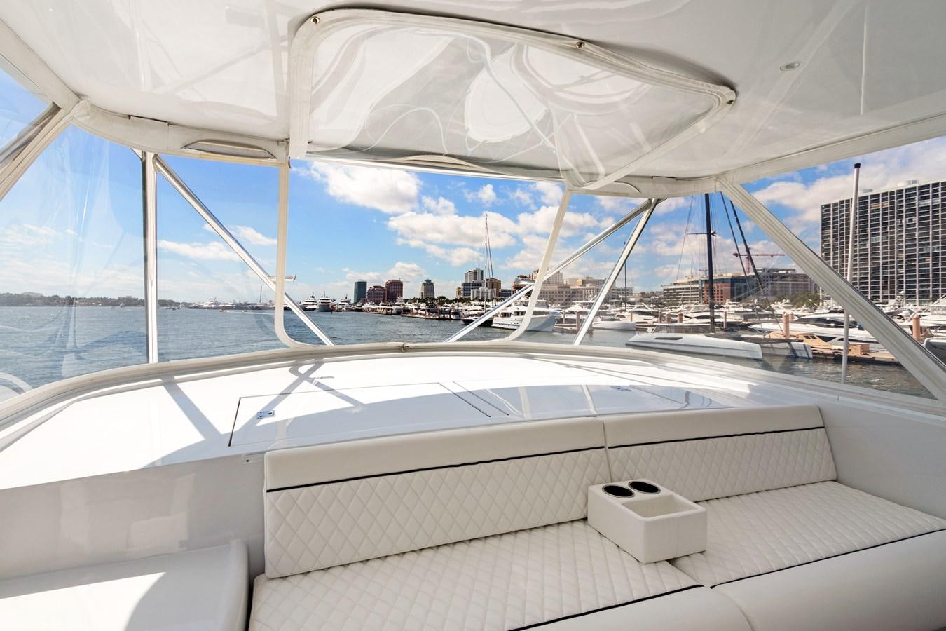 a large white lounge chair on a deck overlooking a body of water aboard TRUE XII Yacht for Sale