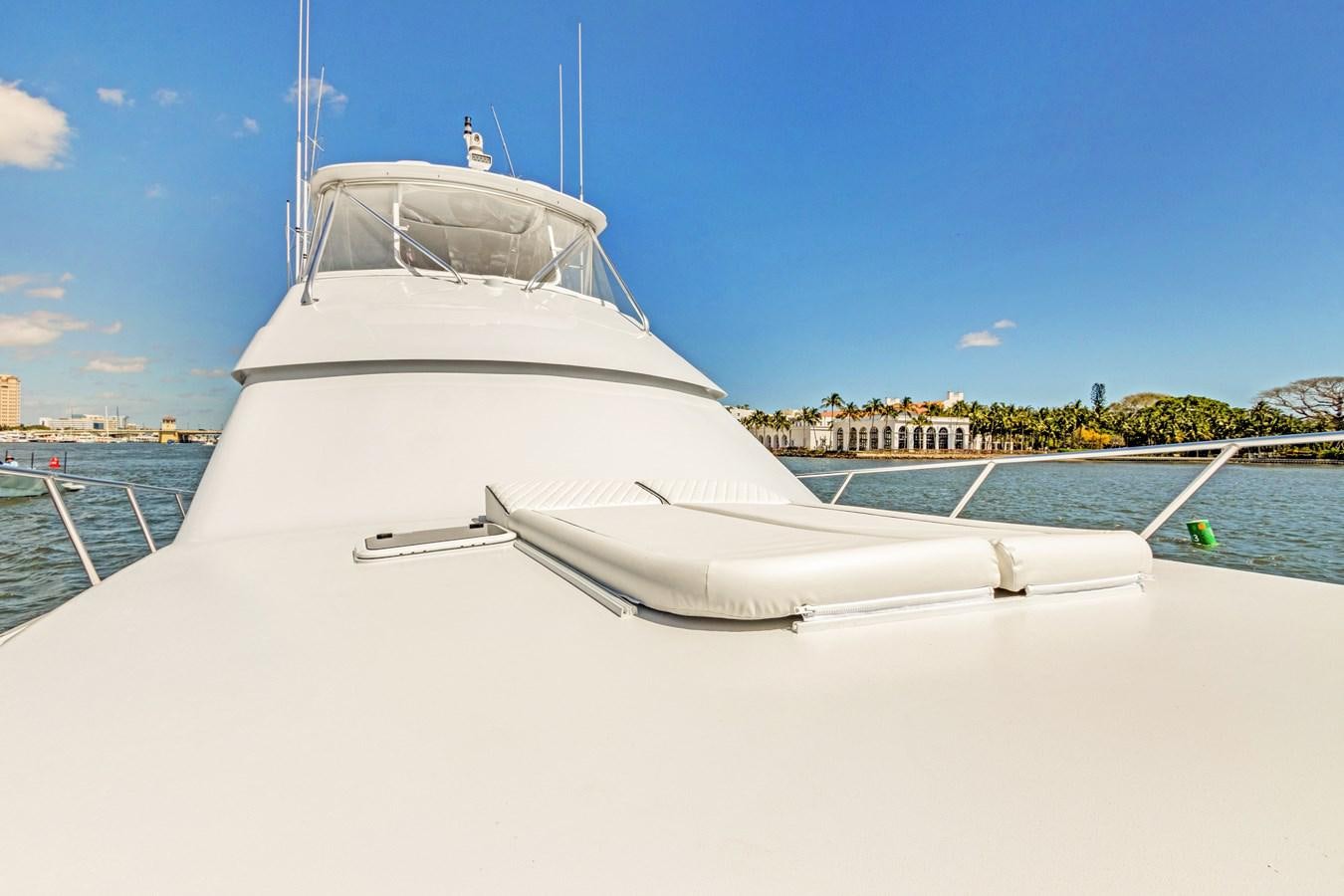 a white boat on a dock aboard TRUE XII Yacht for Sale
