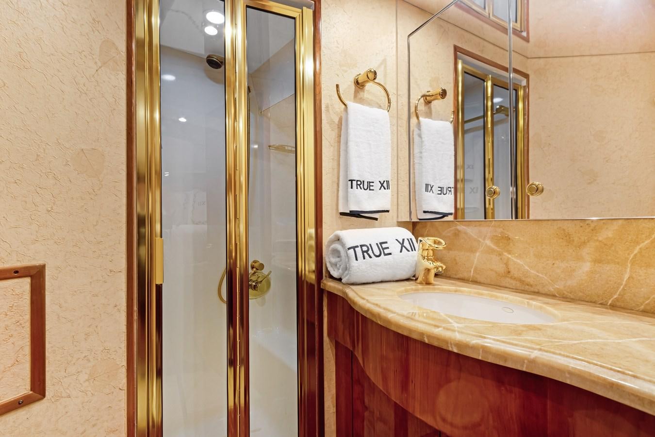 a bathroom with a glass shower aboard TRUE XII Yacht for Sale