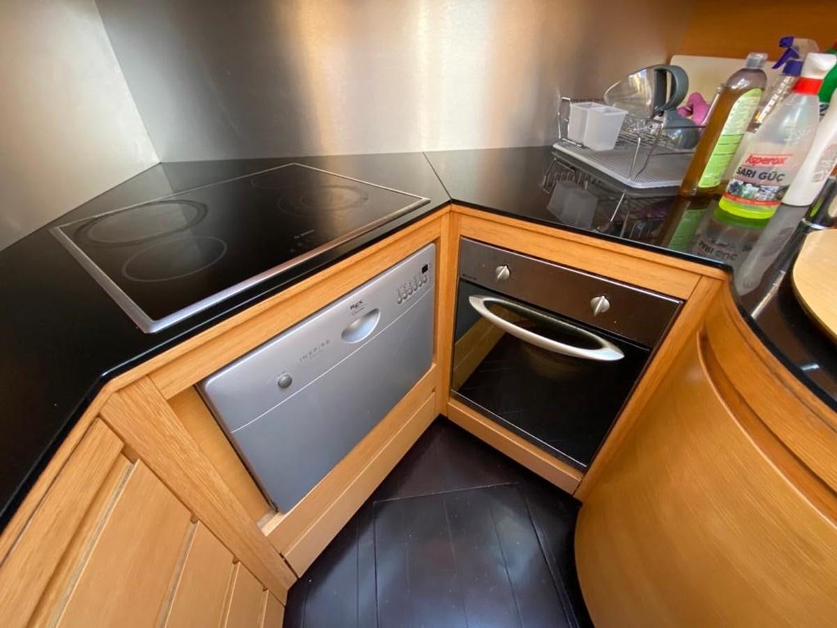 a kitchen with a stove and a sink aboard PERSHING 64 Yacht for Sale