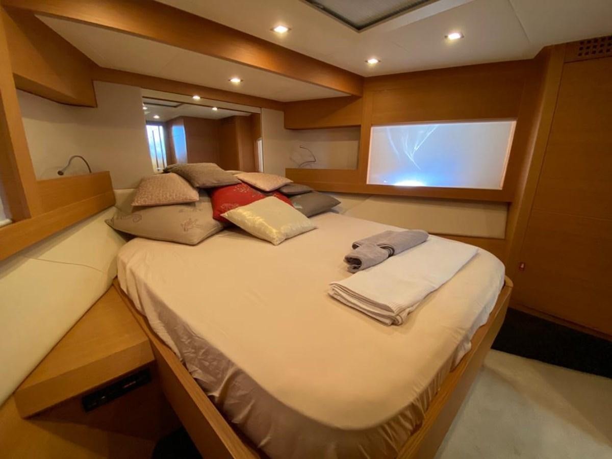 a room with a bed and a window aboard PERSHING 64 Yacht for Sale